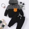Toddler wearing a black striped baby tracksuit with matching jogger pants from ActiveKids Kenya.