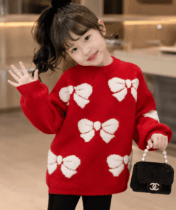 Close-up of white 3D bow jacquard pattern on red knit sweater, kids clothes Kenya